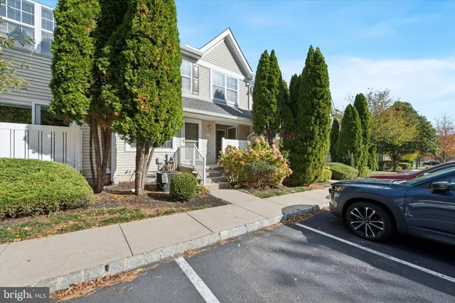 a car parked in front of a white house