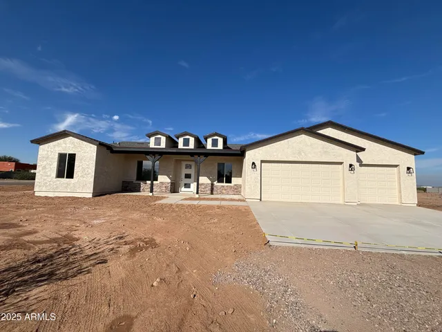 a view of a house with a yard and garage
