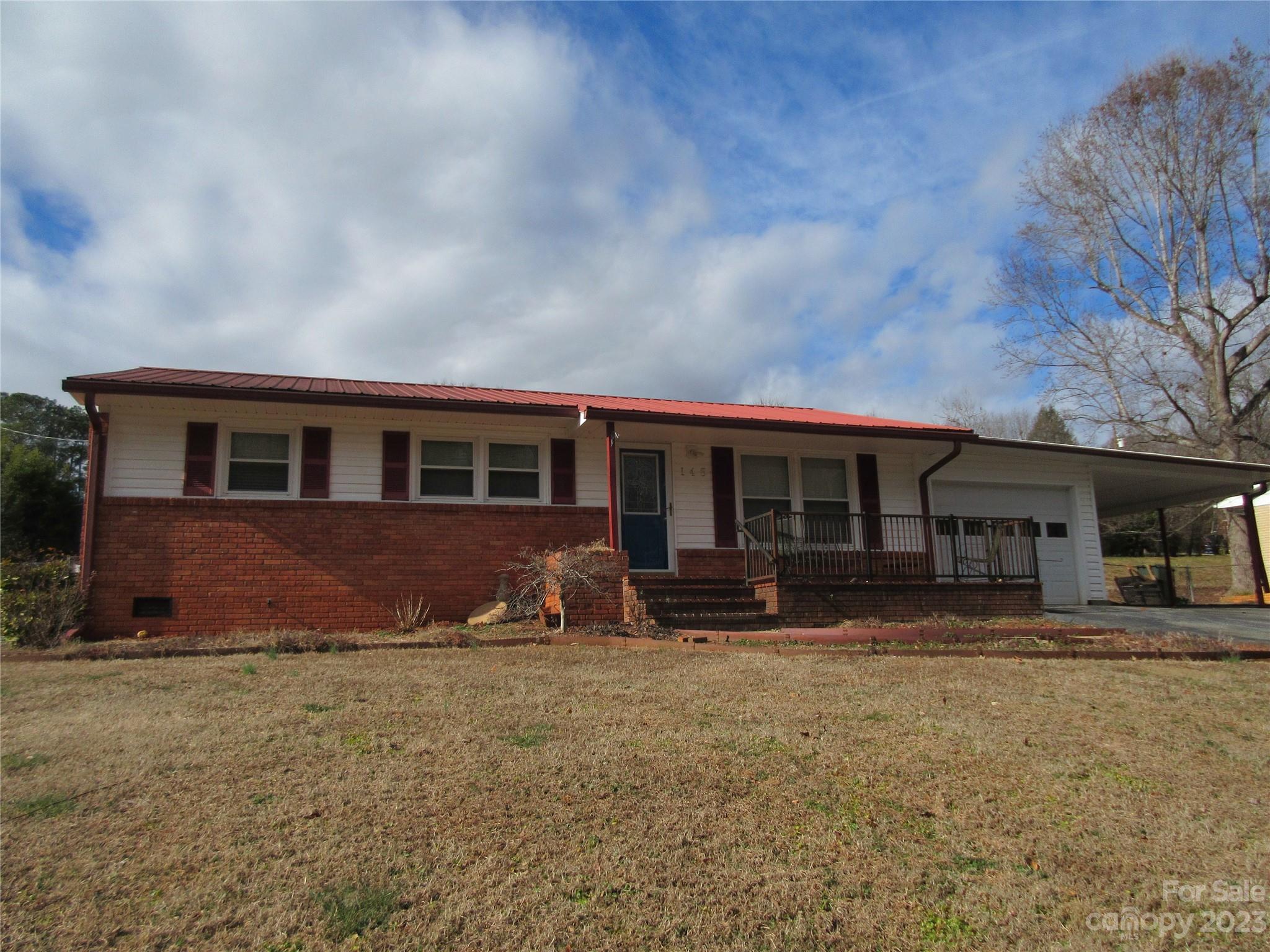 a front view of house with yard and seating space