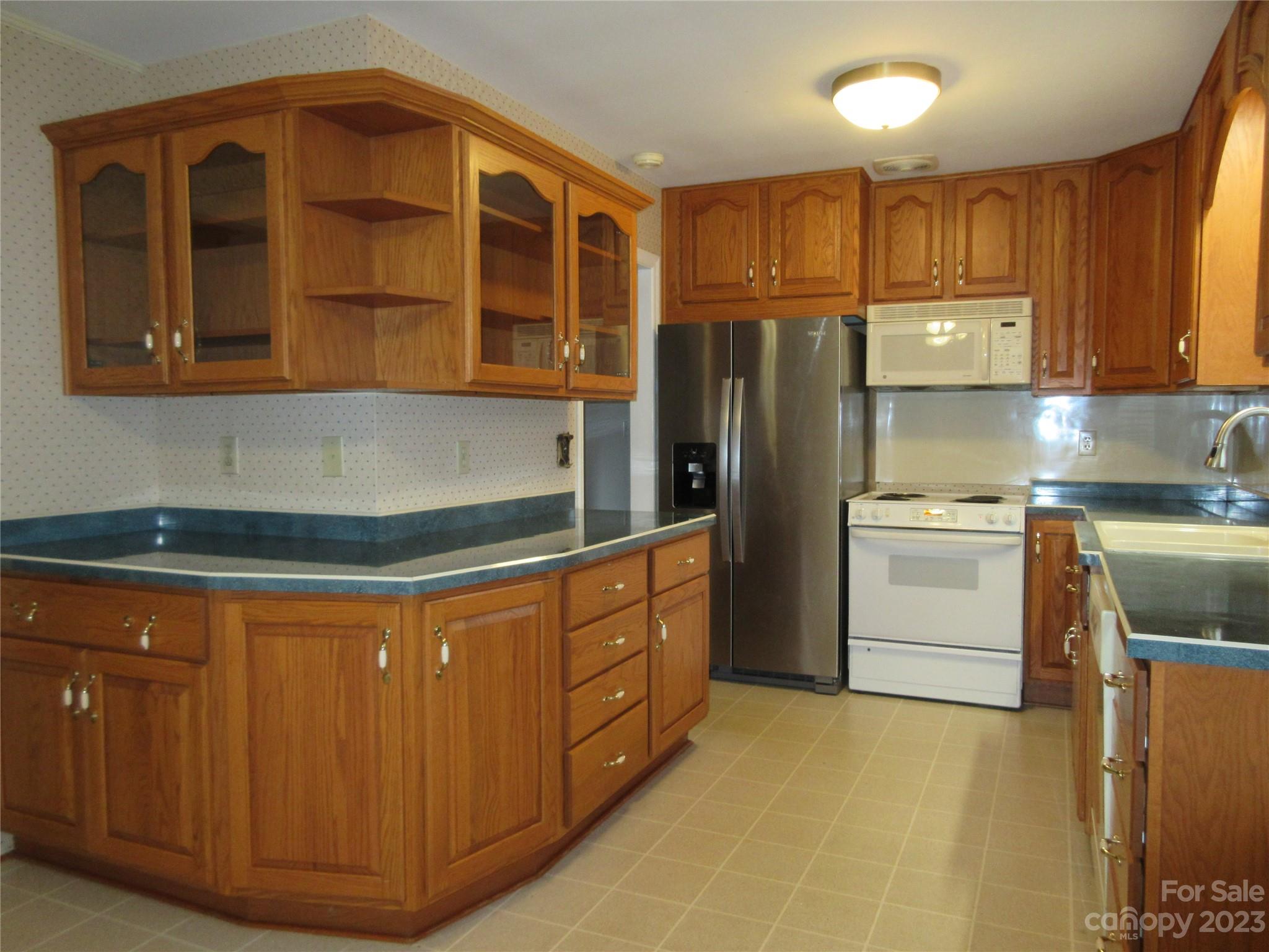 145 Hodge Street Rutherfordton, NC 28139 - Photo 17 of 24 a kitchen with stainless steel appliances granite countertop a stove and a refrigerator