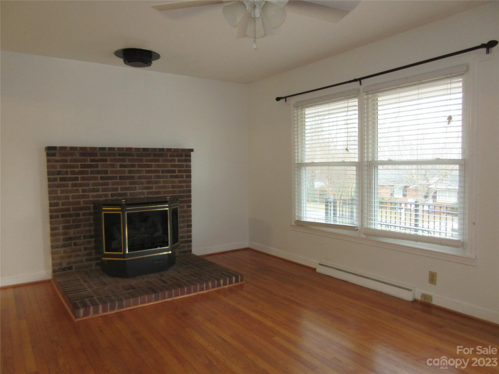 145 Hodge Street Rutherfordton, NC 28139 - Photo 19 of 24 a living room with a fireplace and a window