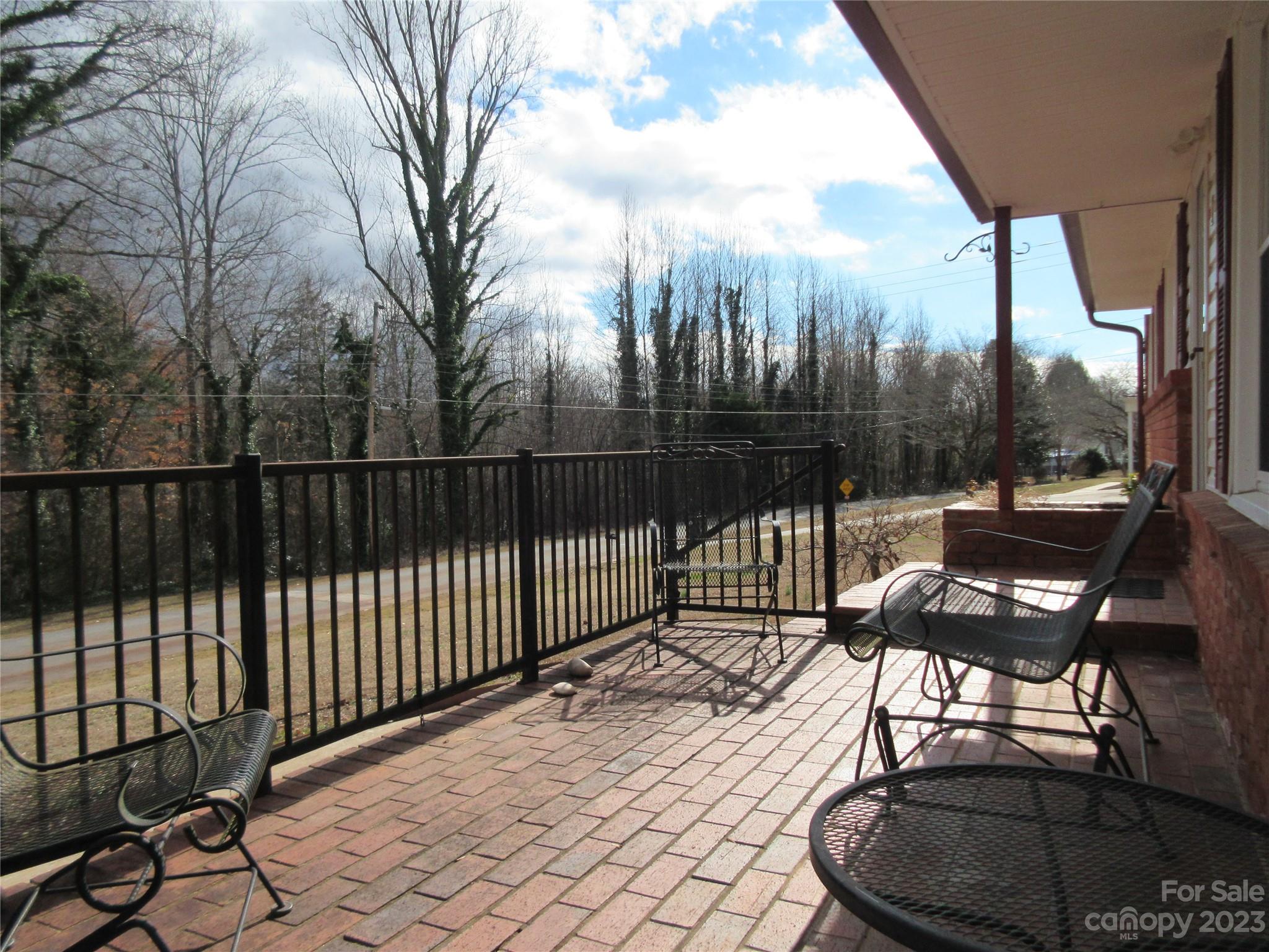 145 Hodge Street Rutherfordton, NC 28139 - Photo 3 of 24 a balcony with wooden floor table and chairs
