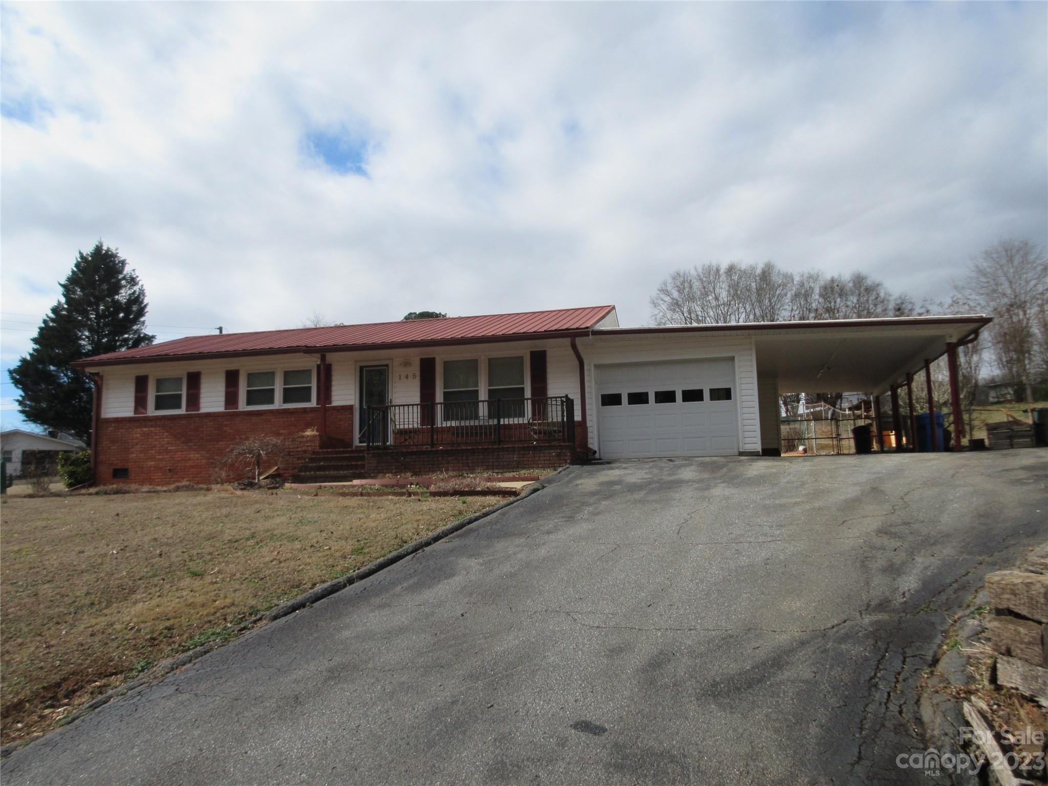 145 Hodge Street Rutherfordton, NC 28139 - Photo 4 of 24 a front view of a house with a garden and balcony