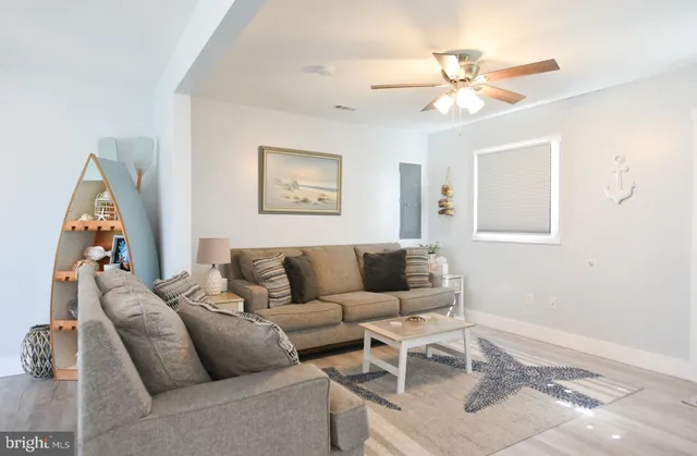 a living room with furniture wooden floor and dining table
