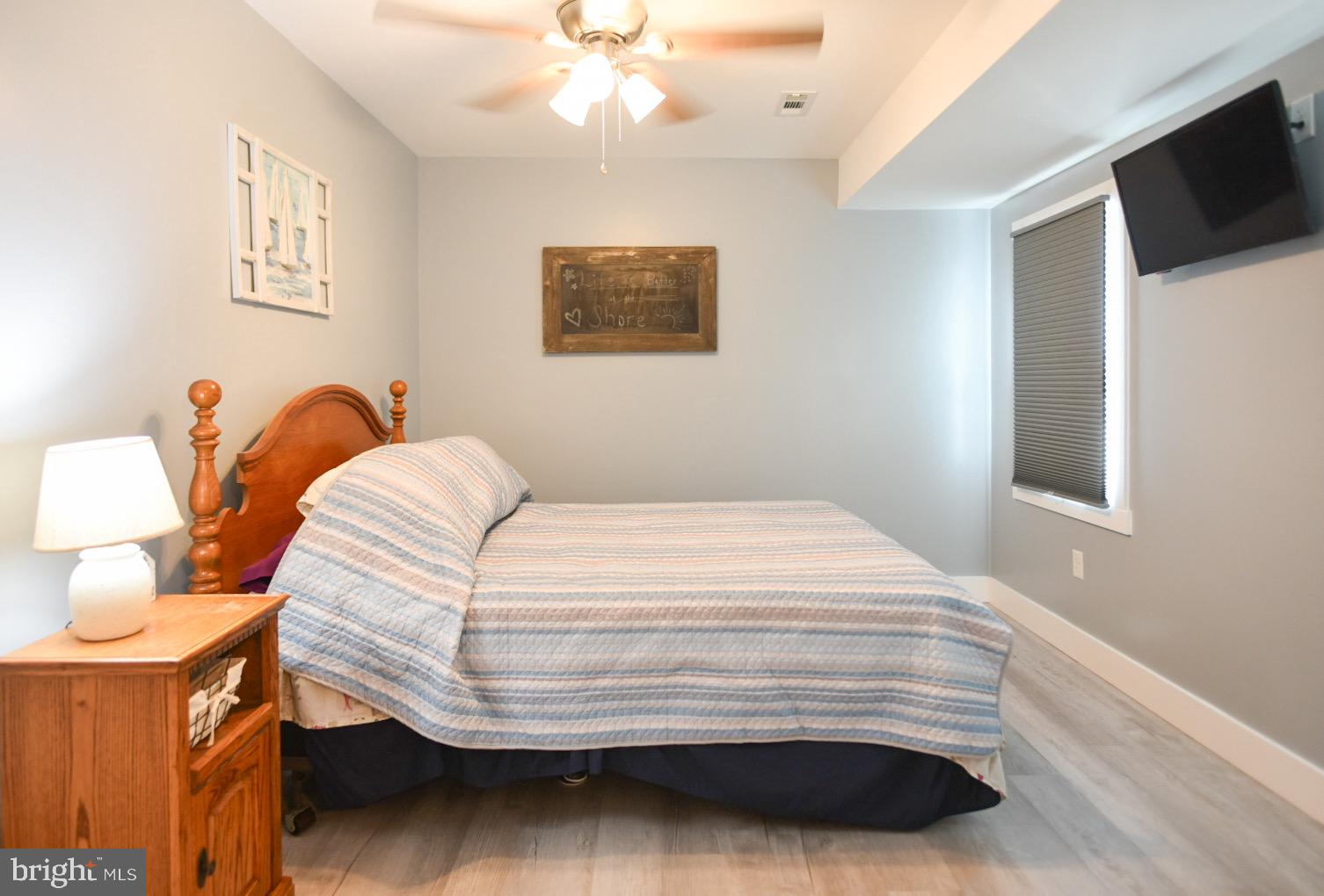 25830 Rumbley Road Westover, MD 21871 - Photo 25 of 59 a bedroom with a bed and a flat screen tv