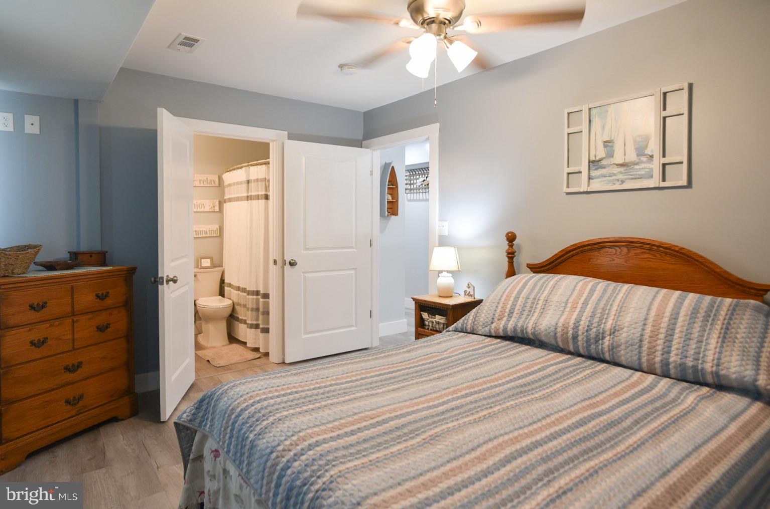 25830 Rumbley Road Westover, MD 21871 - Photo 26 of 59 a bedroom with a bed and a chandelier