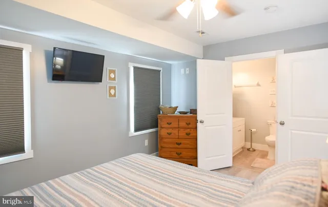 a bedroom with a bed and a mirror