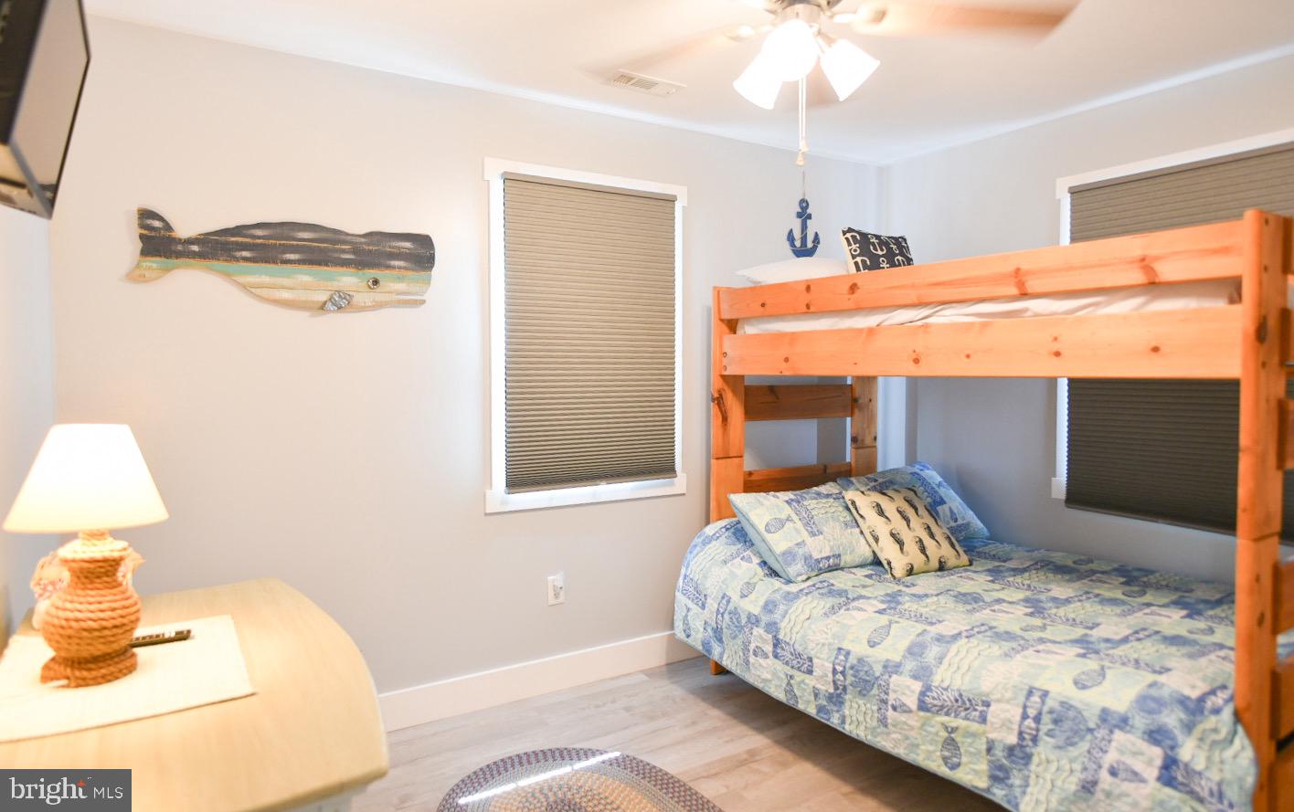 25830 Rumbley Road Westover, MD 21871 - Photo 35 of 59 a bedroom with a bed and a lamp