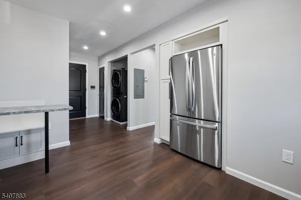 a view of a refrigerator in kitchen and wooden floor