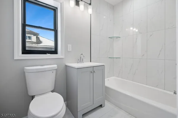 a bathroom with a toilet a sink and bathtub