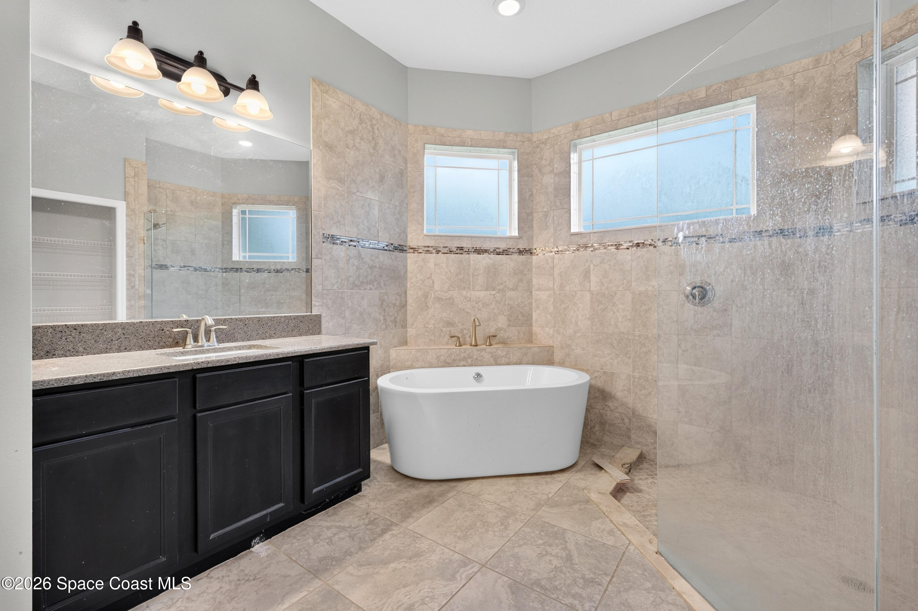 1475 Dalbora Road Merritt Island, FL 32953 - Photo 35 of 57 a bathroom with a bathtub sink a mirror and a shower