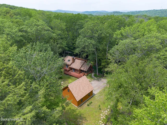 an aerial view of a house with a yard