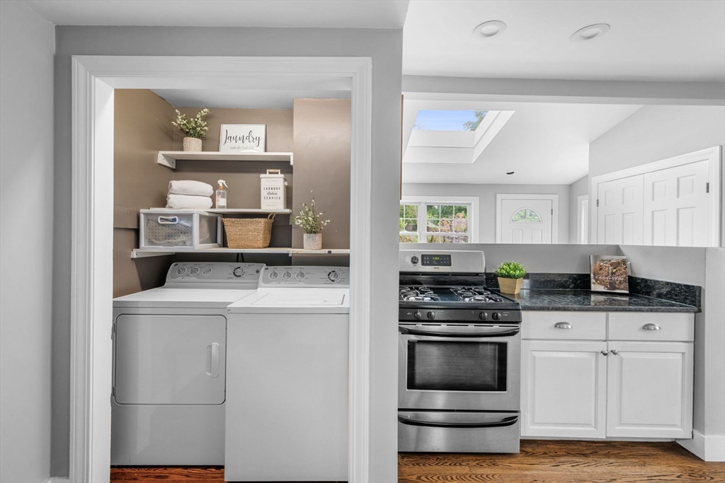 8 Baker Avenue Beverly, MA 01915 - Photo 9 of 40 a kitchen with white cabinets and appliances