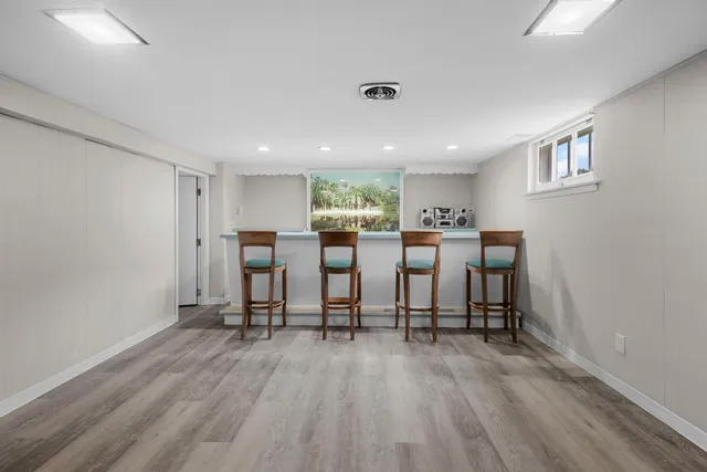 a view of a room with wooden floor and windows