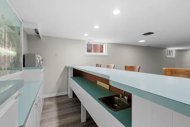 a kitchen with stainless steel appliances a sink and a refrigerator