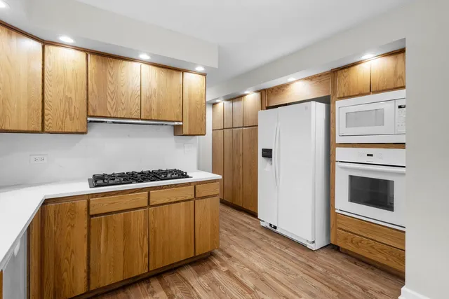 a kitchen with a refrigerator stove and cabinets