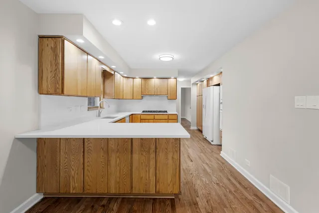 a kitchen with kitchen island a sink and wooden cabinets