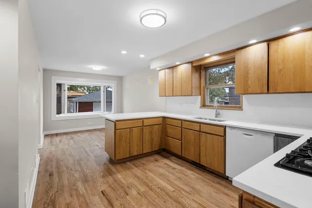 a kitchen with sink cabinets and wooden floor
