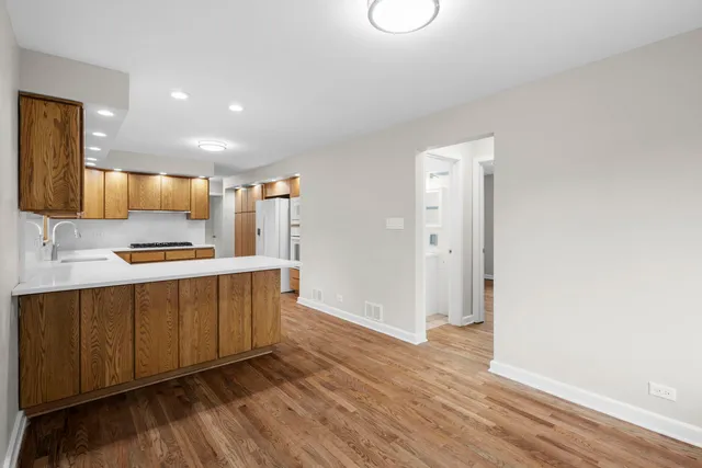 a kitchen with stainless steel appliances a refrigerator and a stove top oven