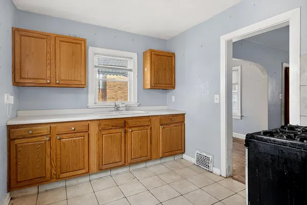 a kitchen with stainless steel appliances granite countertop a sink stove and cabinets