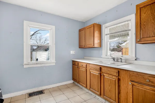 a kitchen with stainless steel appliances granite countertop a sink and a window