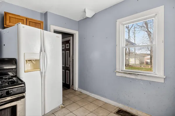 a view of a kitchen with a refrigerator and window
