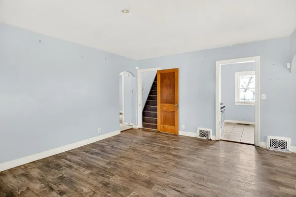 an empty room with wooden floor and closet
