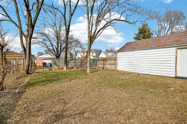 a view of a backyard with large trees