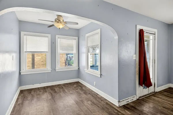 an empty room with windows and closet