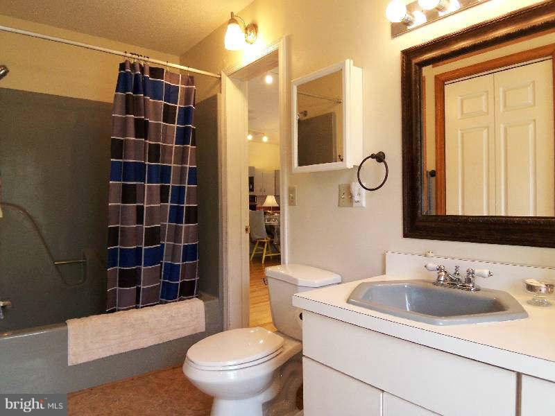667 Morgan Grove Road Shepherdstown, WV 25443 - Photo 12 of 30 a bathroom with a sink toilet vanity and shower