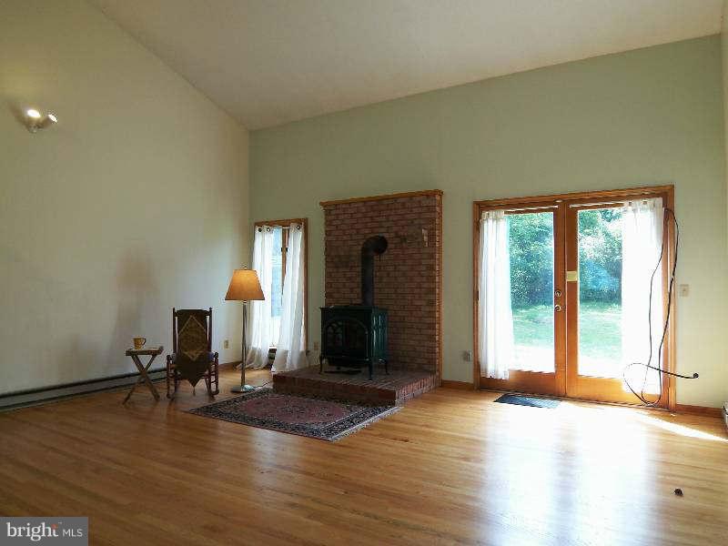 667 Morgan Grove Road Shepherdstown, WV 25443 - Photo 15 of 30 a view of a livingroom with wooden floor and a fireplace