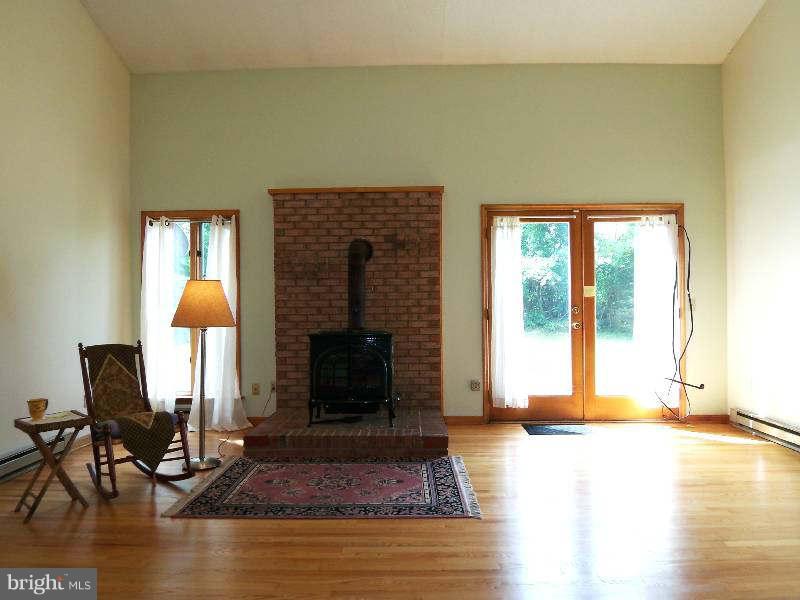 667 Morgan Grove Road Shepherdstown, WV 25443 - Photo 16 of 30 a living room with fireplace furniture and a window