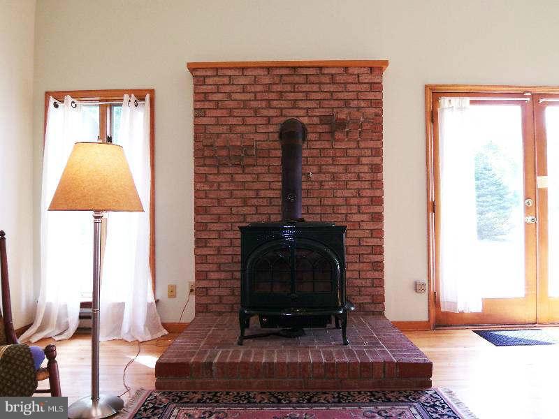 667 Morgan Grove Road Shepherdstown, WV 25443 - Photo 17 of 30 a living room with furniture a rug and a fireplace