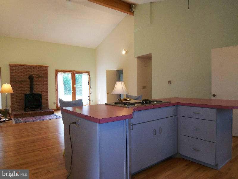 667 Morgan Grove Road Shepherdstown, WV 25443 - Photo 22 of 30 a kitchen with cabinets a sink and dishwasher a stove with wooden floor