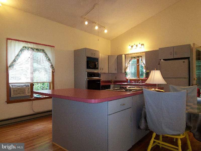 667 Morgan Grove Road Shepherdstown, WV 25443 - Photo 23 of 30 a kitchen with kitchen island granite countertop wooden cabinets and stainless steel appliances