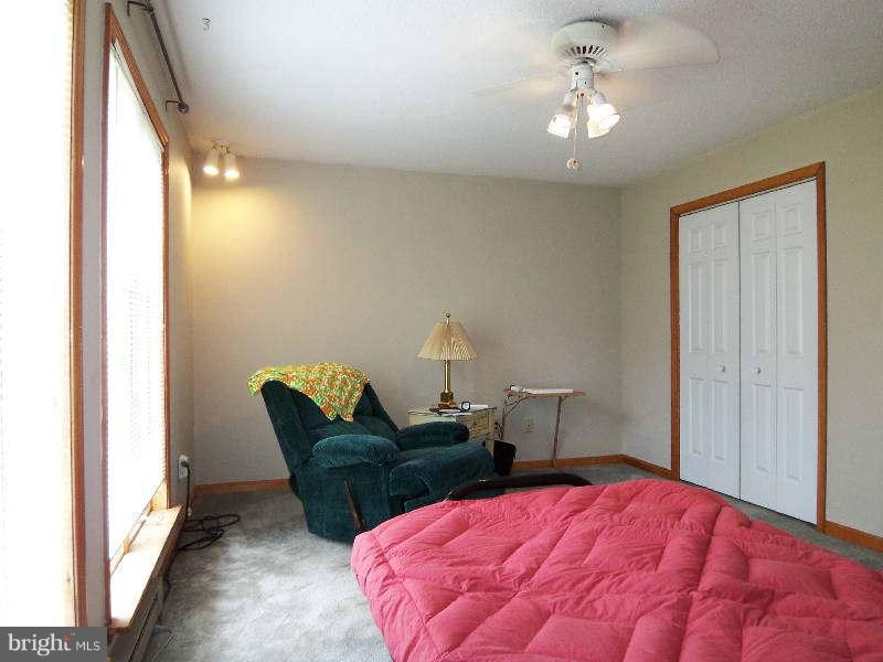 667 Morgan Grove Road Shepherdstown, WV 25443 - Photo 28 of 30 a bedroom with a bed and a chair