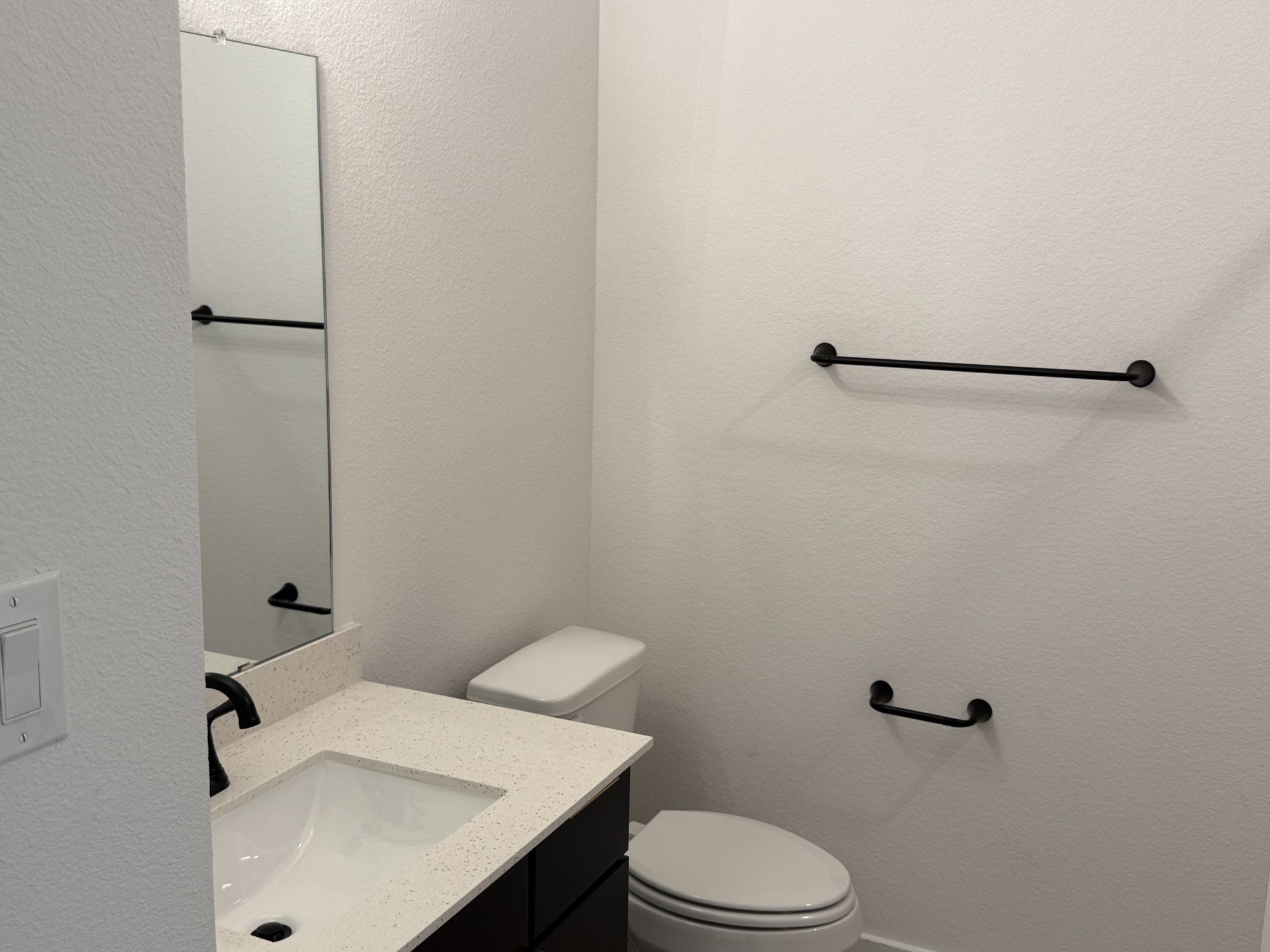 5111 Getty Lane Manvel, TX 77578 - Photo 11 of 38 a bathroom with a sink and mirror with toilet