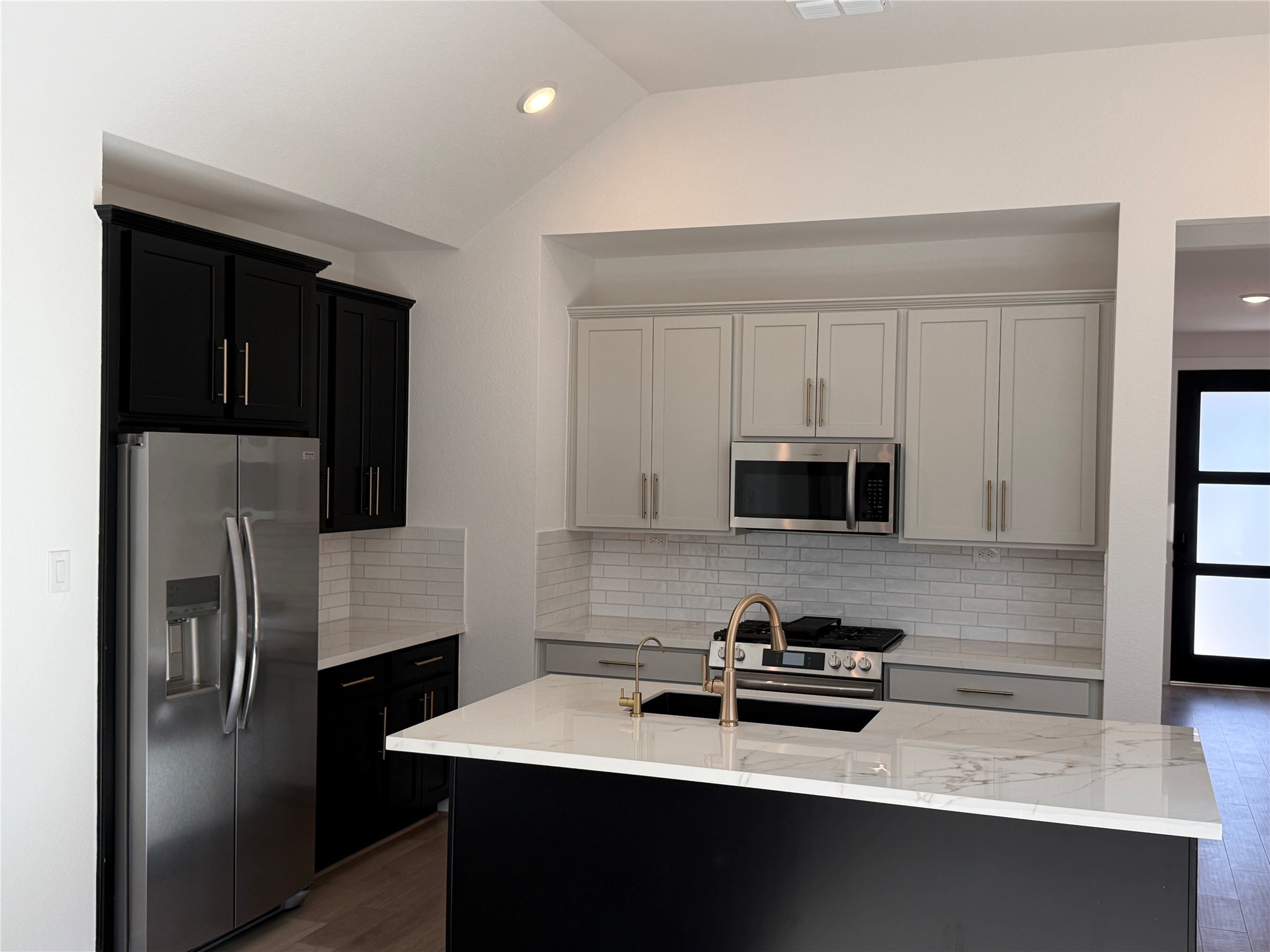 5111 Getty Lane Manvel, TX 77578 - Photo 4 of 38 a kitchen with a refrigerator and a stove top oven
