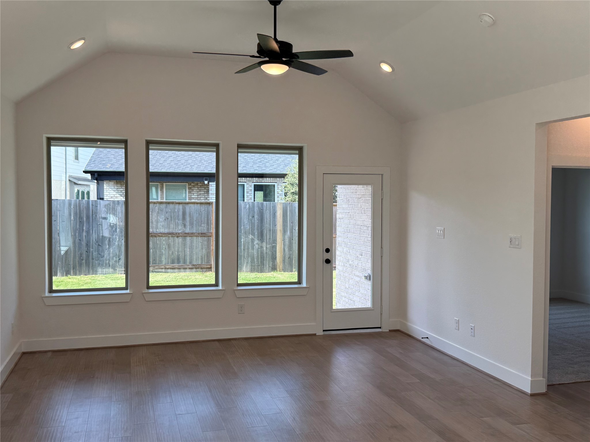 5111 Getty Lane Manvel, TX 77578 - Photo 5 of 38 an empty room with wooden floor and windows