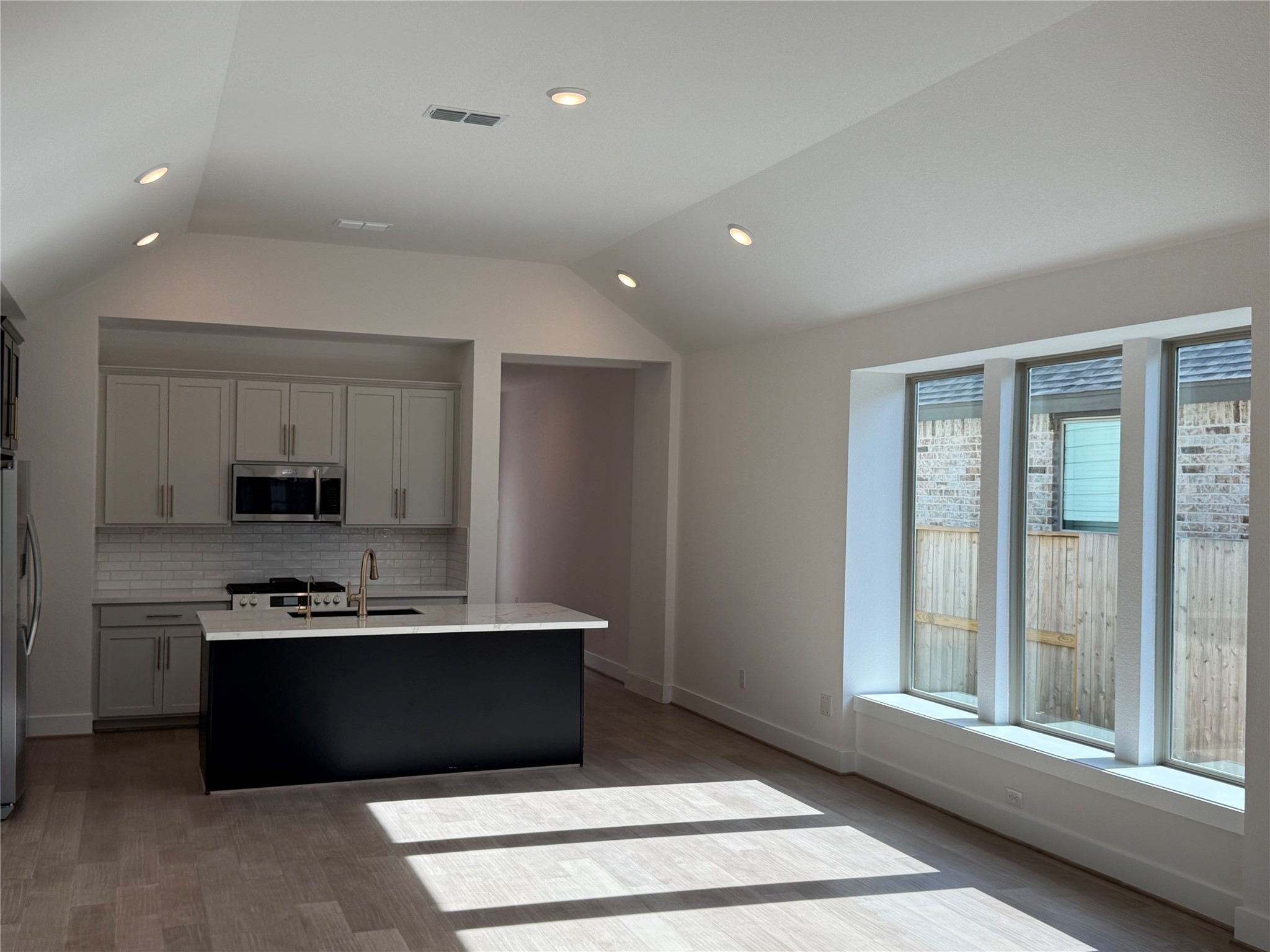 5111 Getty Lane Manvel, TX 77578 - Photo 9 of 38 a kitchen with stainless steel appliances granite countertop a stove a sink and a microwave
