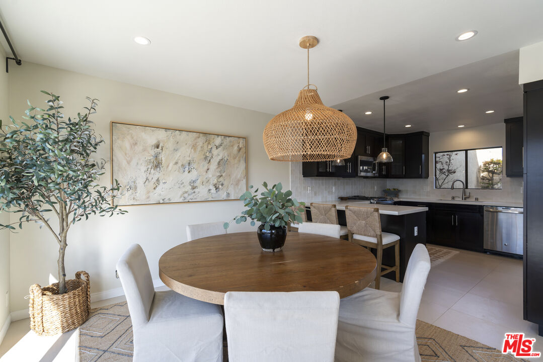 4555 Falkirk Bay, Unit BAY Oxnard, CA 93035 - Photo 12 of 46 a view of a dining room with furniture and chandelier