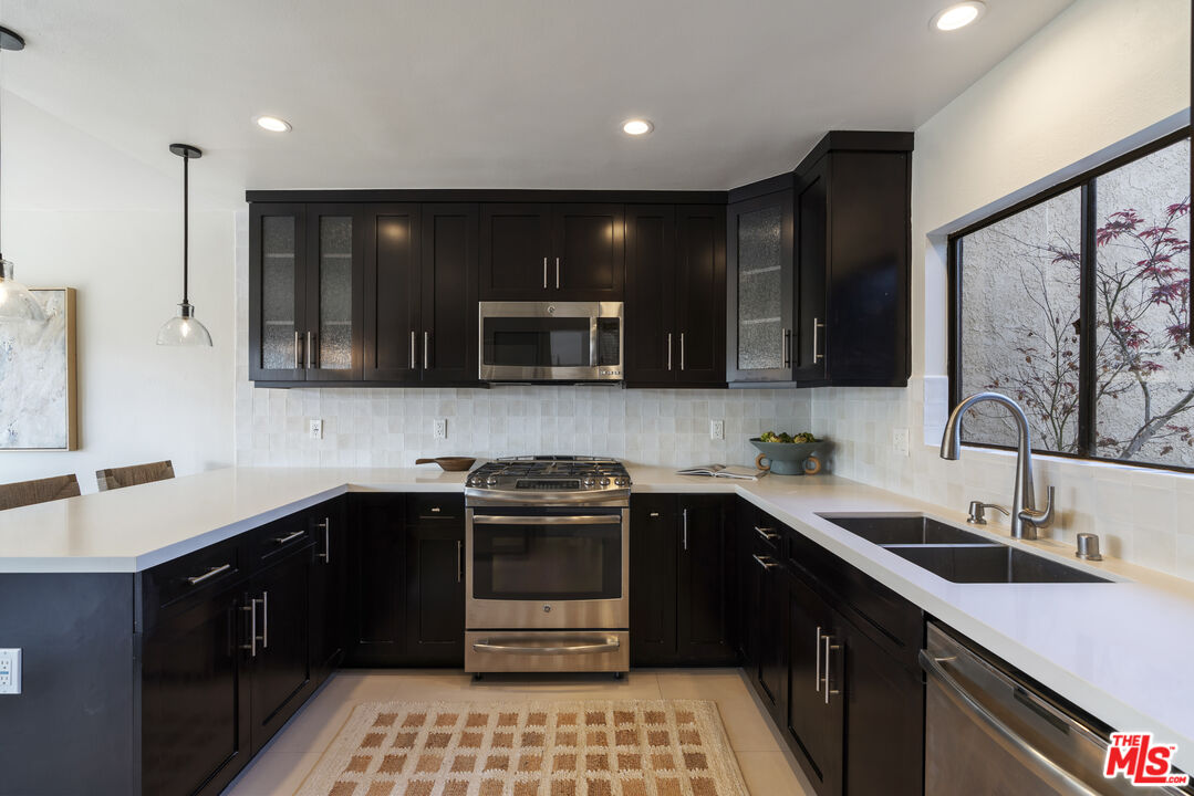 4555 Falkirk Bay, Unit BAY Oxnard, CA 93035 - Photo 14 of 46 a kitchen with a sink and steel appliances