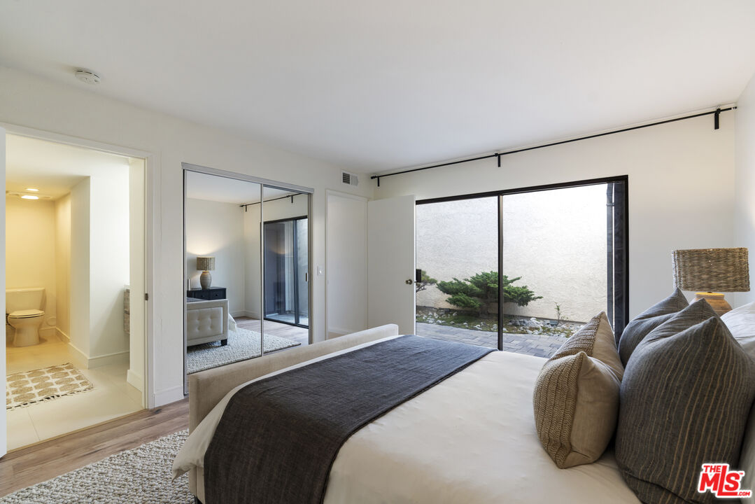 4555 Falkirk Bay, Unit BAY Oxnard, CA 93035 - Photo 30 of 46 a bedroom with a bed and large windows