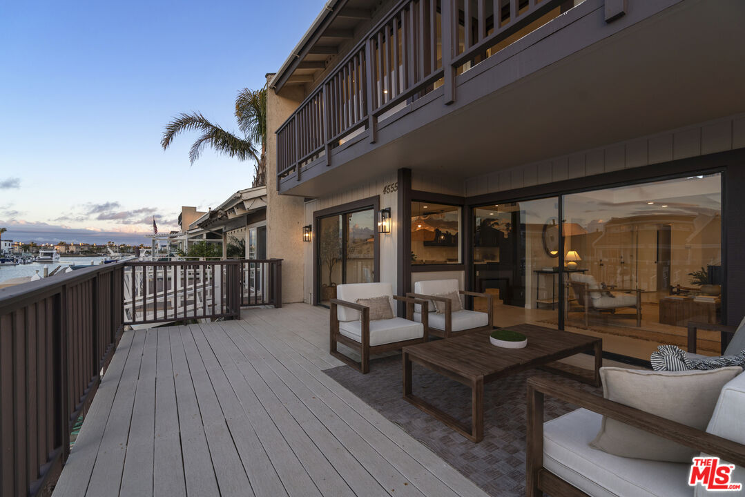 4555 Falkirk Bay, Unit BAY Oxnard, CA 93035 - Photo 38 of 46 a balcony with furniture and wooden floor