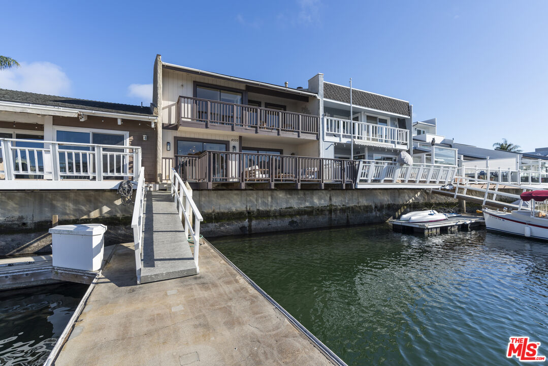 4555 Falkirk Bay, Unit BAY Oxnard, CA 93035 - Photo 39 of 46 a view of a lake with a barbeque and wooden stairs