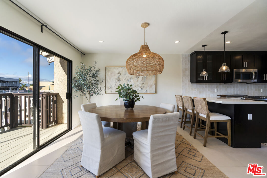4555 Falkirk Bay, Unit BAY Oxnard, CA 93035 - Photo 4 of 46 a view of a dining room with furniture wooden floor and chandelier