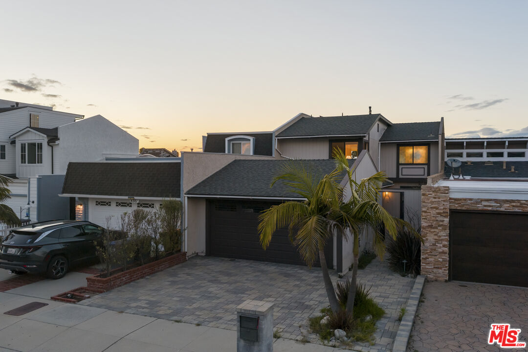 4555 Falkirk Bay, Unit BAY Oxnard, CA 93035 - Photo 46 of 46 a yellow house with trees in front of it