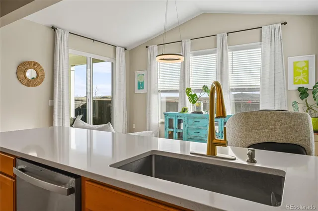 a living room with furniture and large windows