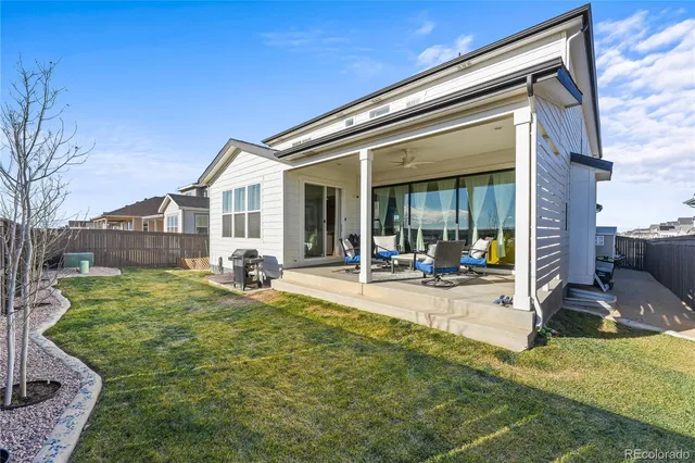 a view of a house with backyard porch and sitting area