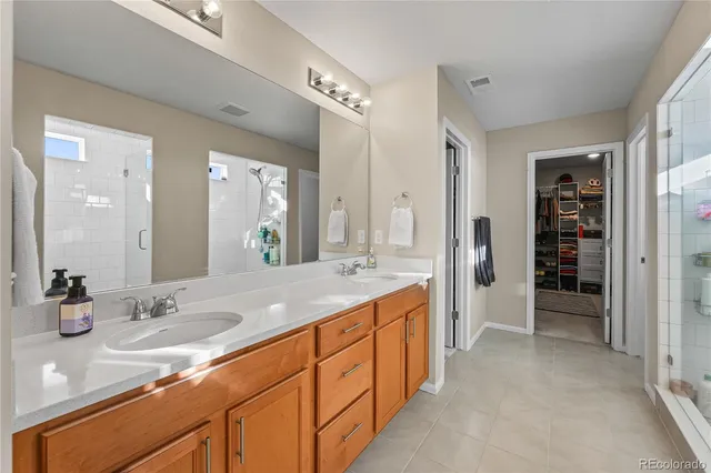 a spacious bathroom with a granite countertop sink mirror and shower